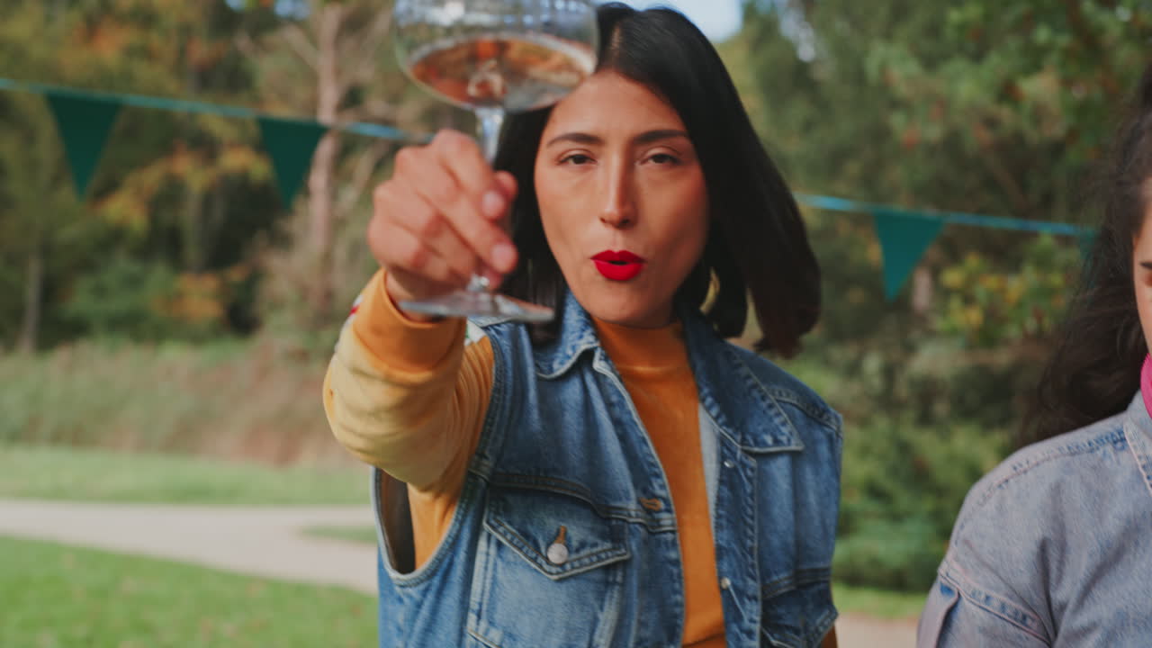 Woman enjoying a drink at an outdoor festival
