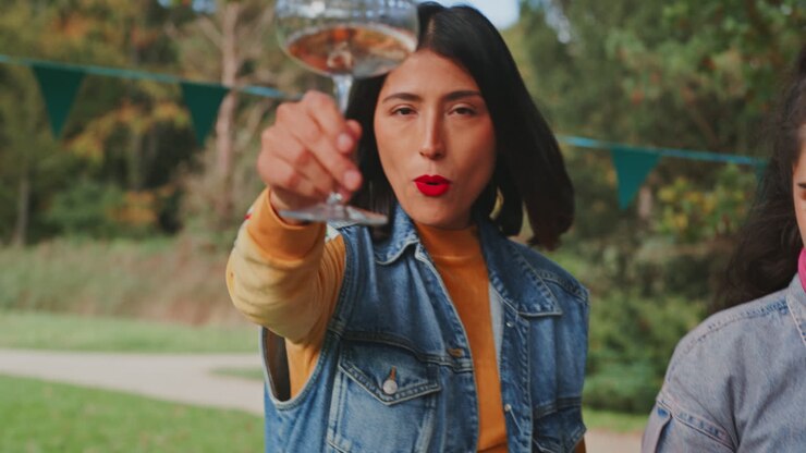 Woman enjoying a drink at an outdoor festival