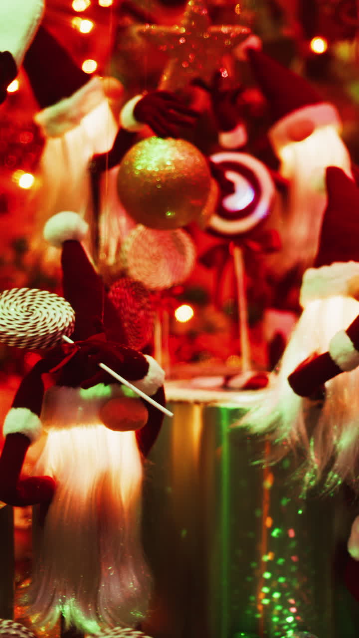Multiple Santa Claus Christmas decorations moving in bubbles in the courtyard of the Monte Carlo Casino. Vertical