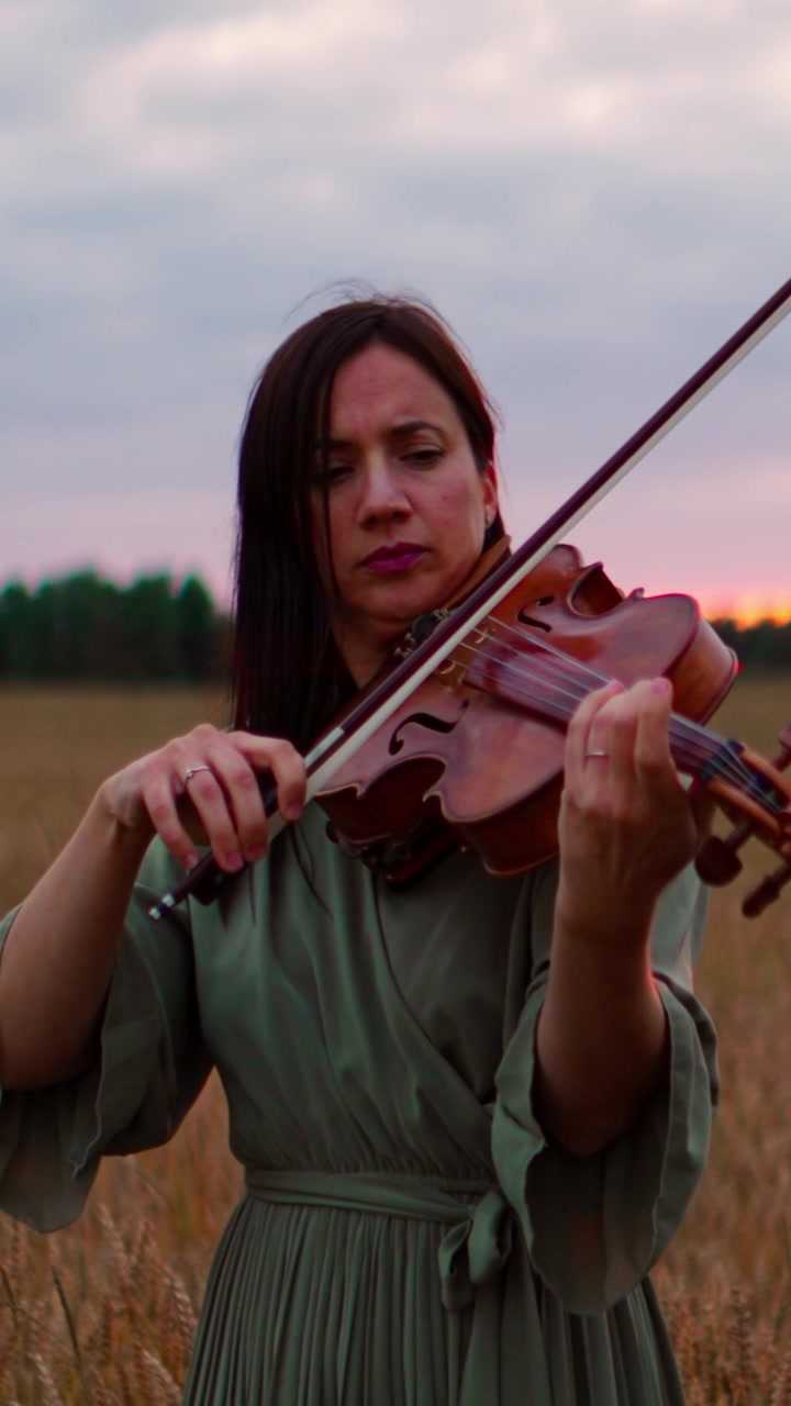 Woman Playing Violin in a Wheat Field at Sunset