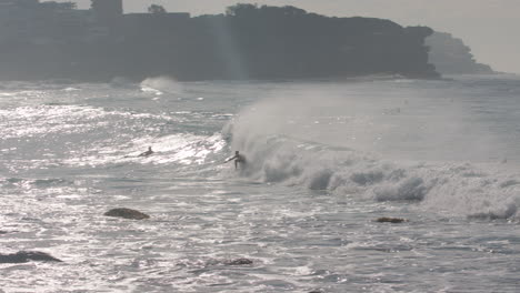 find and zoom in on a surfer catching an awesome wave at manly beach in sydney australia