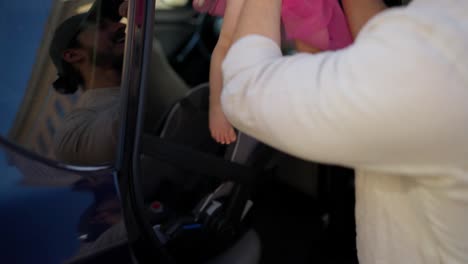 a father holding his baby daughter in a car