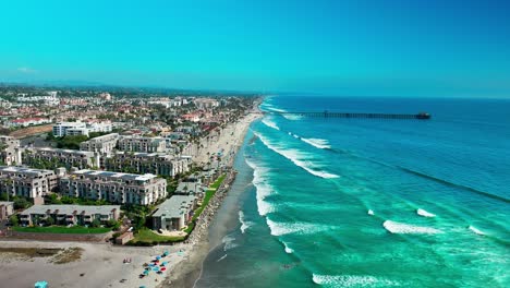 Harbor-in-Oceanside-California-flying-towards-the-Pier-over-the-beach-sand-surf-bike-path-boats-and-marina,-Part-2