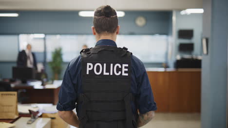 Back-of-police-officer-vest-in-precinct