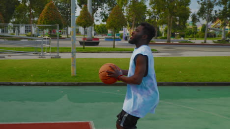 man playing basketball outdoors