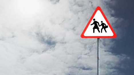 Pedestrian-crossing-sign-board-post-against-clouds-in-the-blue-sky