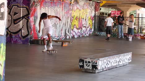 skateboarders performing tricks in urban skatepark