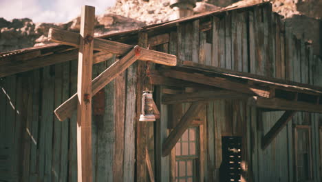 old wooden structure with rustic lantern against rocky backdrop in daylight