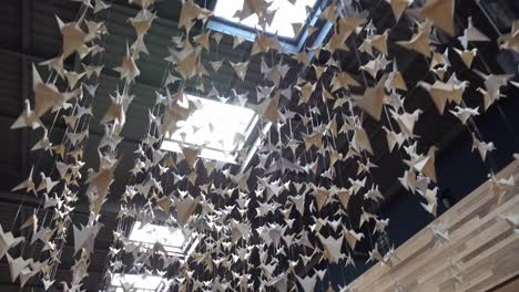 white paper cranes hanging from the ceiling