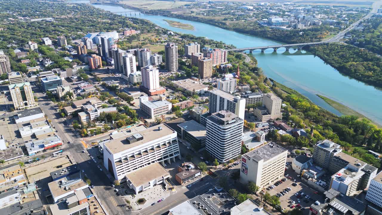 Aerial orbit of Saskatoon downtown in fall, streets, traffic, bridge, buildings