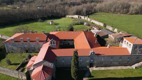 orange roof and fine masonry walls of san salvador de ferreira monastery, drone