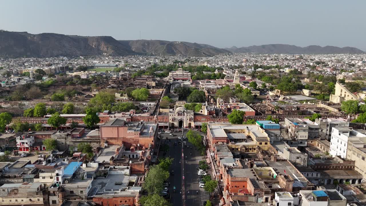 Scenic aerial of central Jaipur showing roads, trees, and distant mountain range