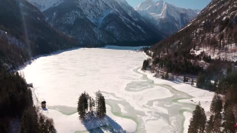 Lago-del-Predil,-Tarvisio---Italy-a-frozen-alpine-lake-in-a-snow-covered-winter-fairytale-mountain-landscape