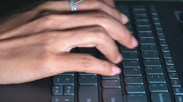 Close Sot of Female Hands Typing on a Laptop Computer
