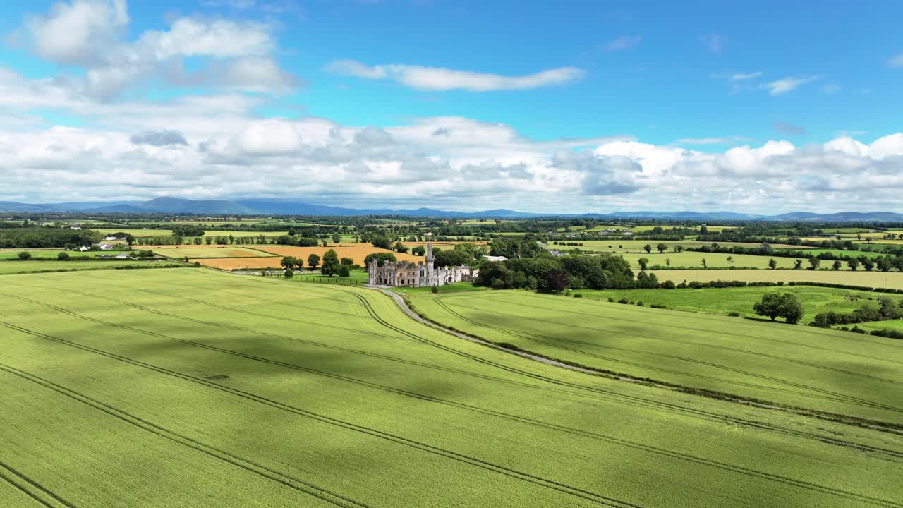 Aerial landscape drone flying over crops to Ducketts Grove Castle Carlow Ireland in high summer