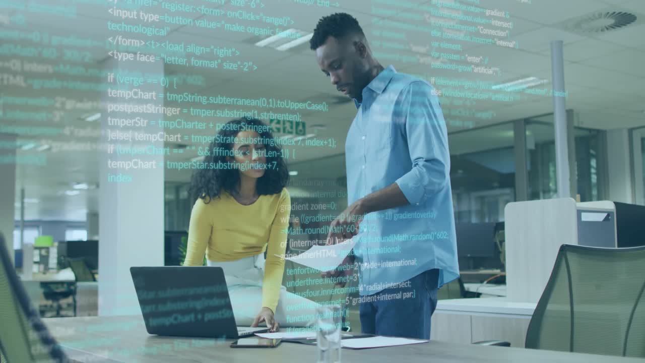 woman and man collaborating in tech office, displaying animated code overlay on laptop