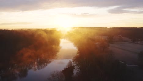 beautiful sunrise aerial through fog on saluda river in south carolina