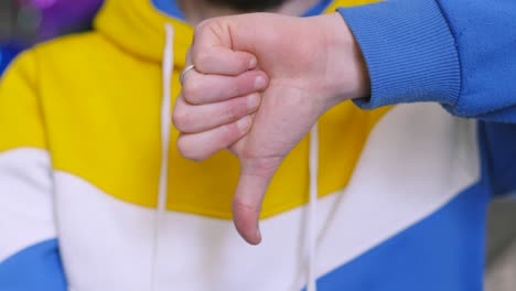 male person giving thumbs down to an idea or action. illustrative sign of displeasure about a subject. concept people footage.