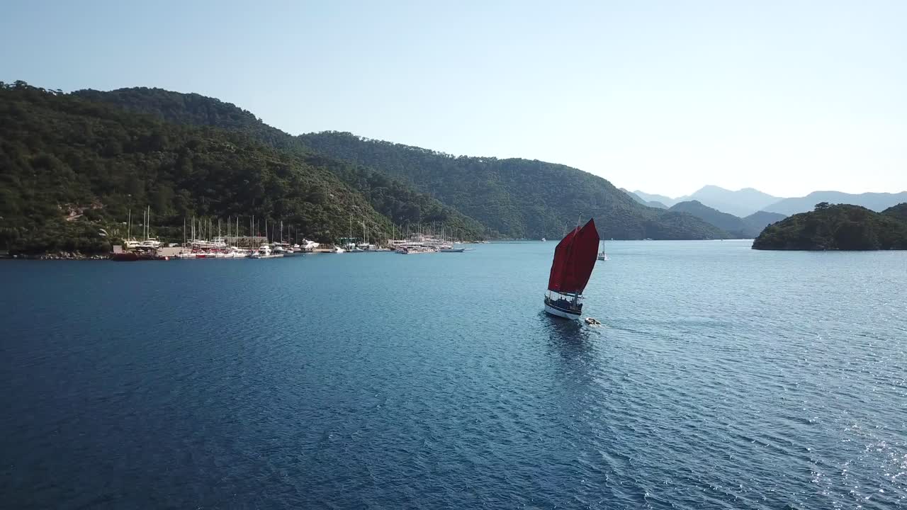 Drone shot of a moving sailing boat.