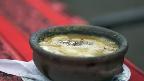 hot boiling traditional humita argentine peasant dish served in a casserole, close up