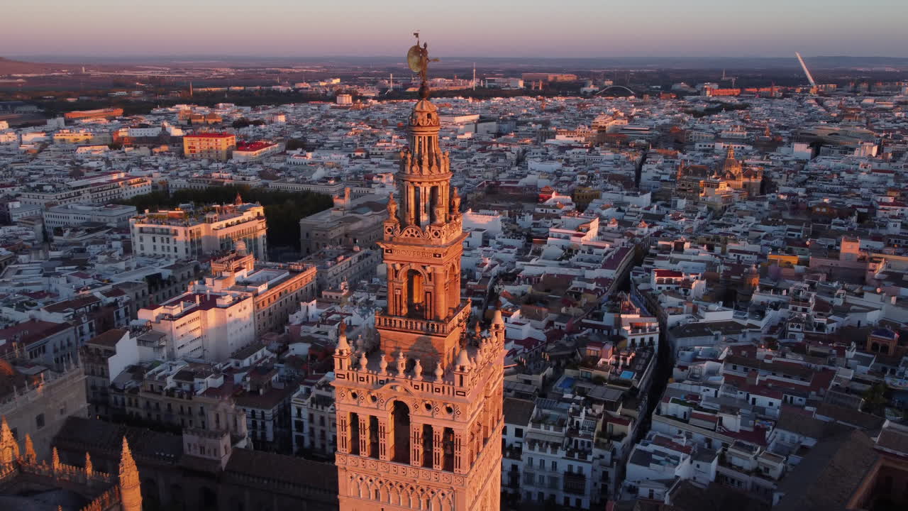 Giralda of Seville Cathedral lit up by sunset