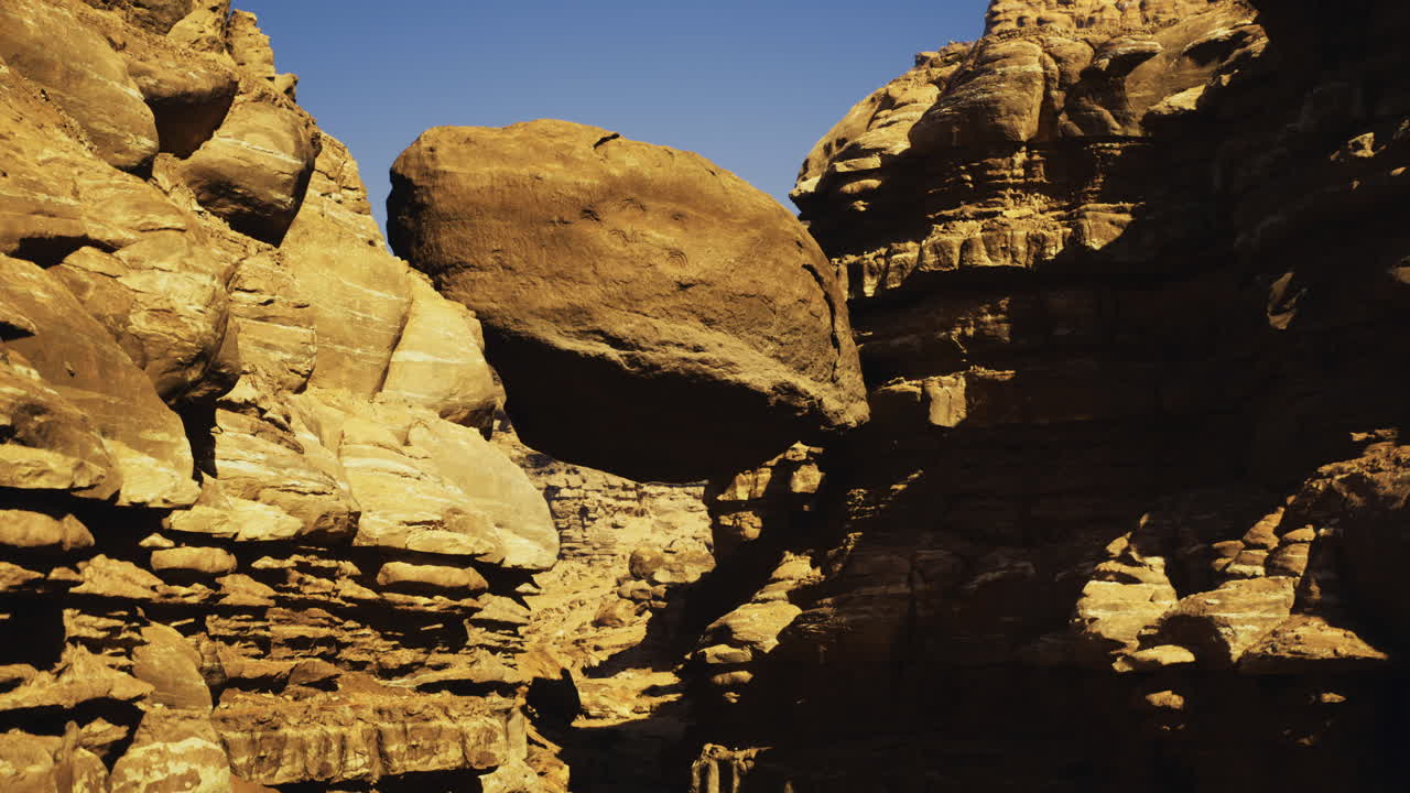 Unique rock formation in a canyon under clear blue sky during daytime