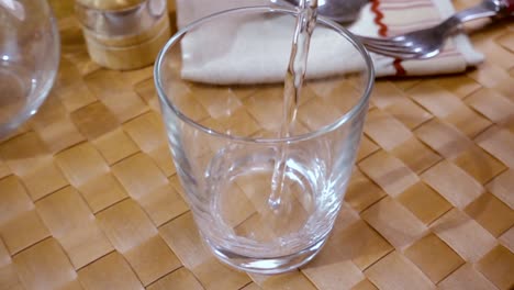 Mineral-water-pouring-into-a-glass,-the-morning-Breakfast,-Slow-motion-with-rotation-tracking-shot.