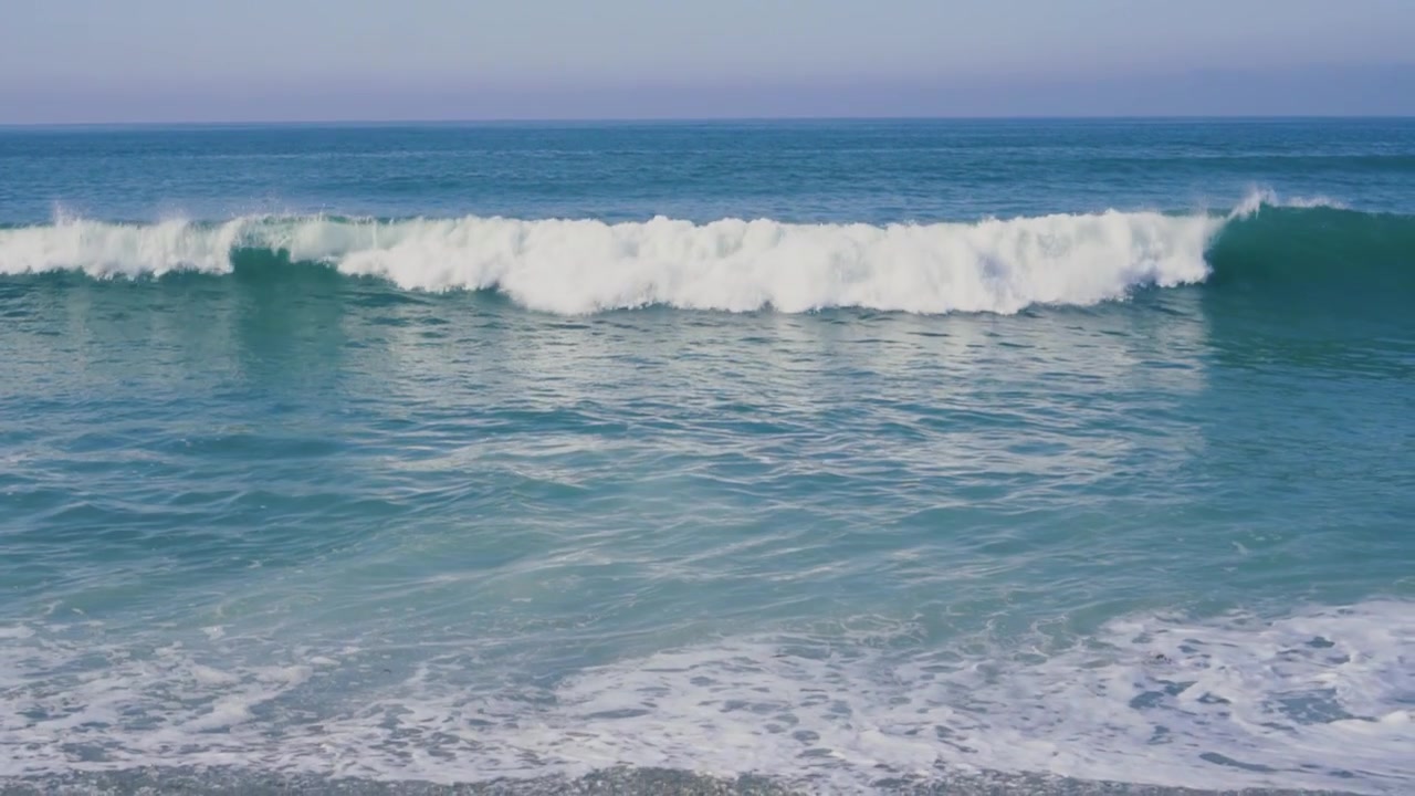 Large Ocean Wave Breaking and Rolling Towards the Beach