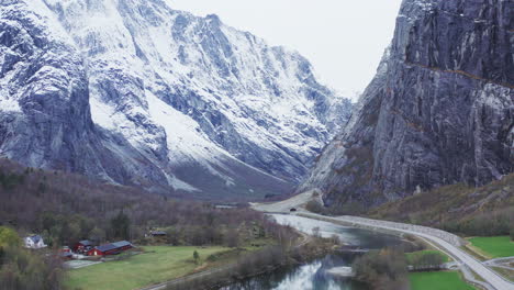 Scenic-View-Of-Road-And-Mountains-Covered-In-Snow-By-Trollveggen,-Norway