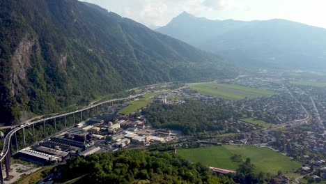 aerial pan left from a polluted valley to a highway in the mountains