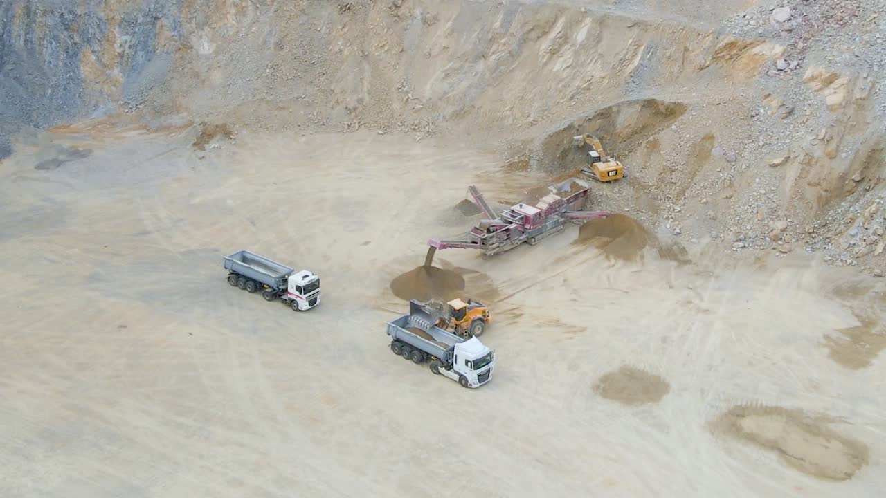 Heavy machines extracting and crushing stones