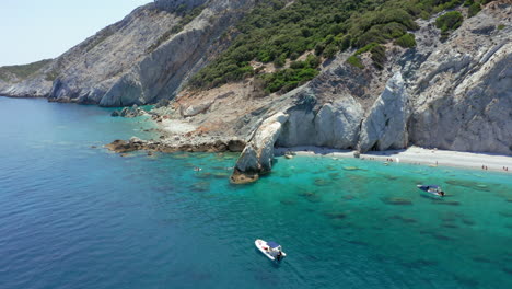 aerial: slow orbit shot of lalaria beach in skiathos island, sporades, greece with turquoise and emerald crystal clear water