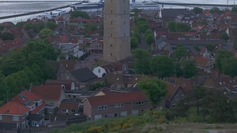 Tilt-up-shot-of-NorthSea-shipping-traffic-control-center-in-lighthouse-of-Terschelling-island,-aerial