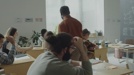 a teacher supervises students in a diverse classroom setting