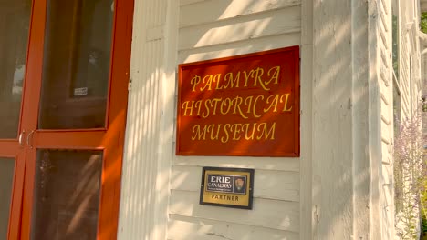 Push-in-shot-of-the-sign-on-the-Palmyra-museum-in-Downtown-Palmyra-New-York