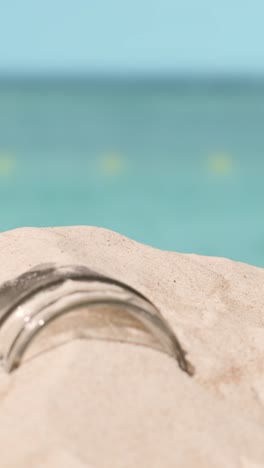 Vertical-Video-Pollution-Concept-With-Glass-Jar-On-Beach-Against-Sea-Background