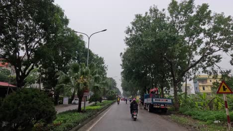 people and vehicles moving on a wet street