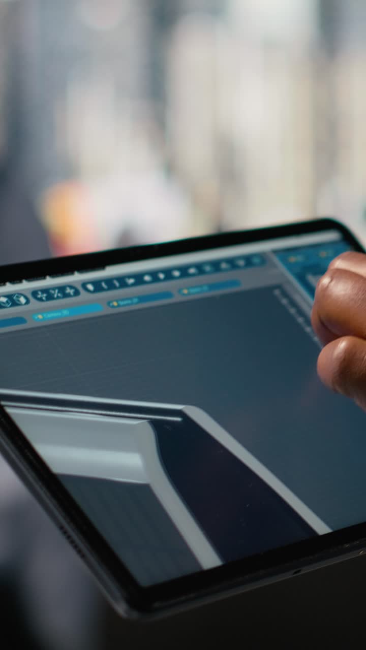 Close up of technician using tablet to create solar powered device design