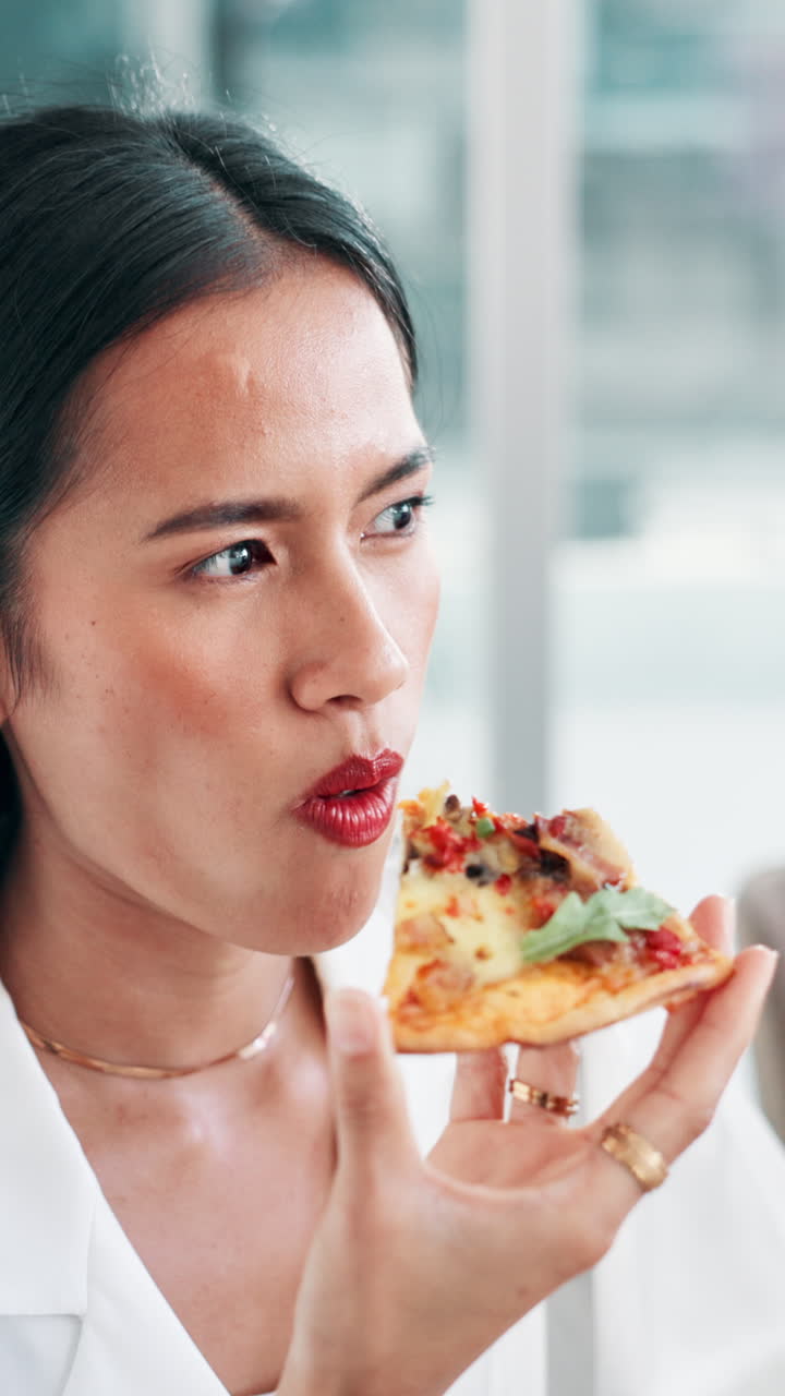 Young Woman Eating a Slice of Delicious Pizza