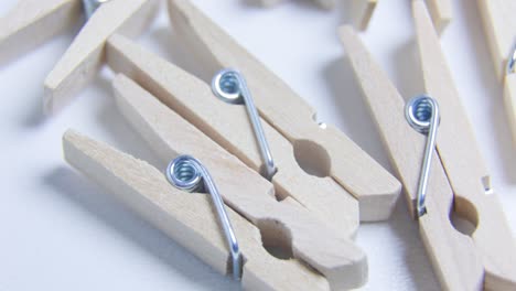 close up view of a rotating wooden mini clothespins textured background