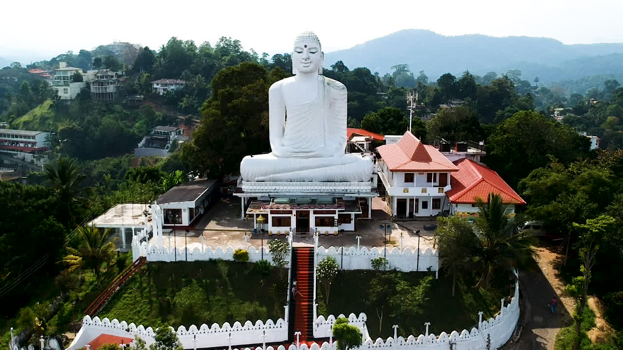 Aerial of Big White Buddha statue in Kandy