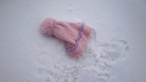 pink knitted hat in the snow
