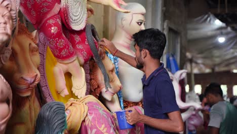 in kumortuli, idol artists are making idols of durga, the revered deity of hinduism. the work of making these idols starts from june and these potters make many idols till november.