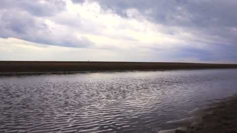 large water outlet from a treatment plant on the beach and in the direction of the sea