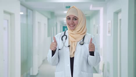 happy muslim doctor showing thumbs up