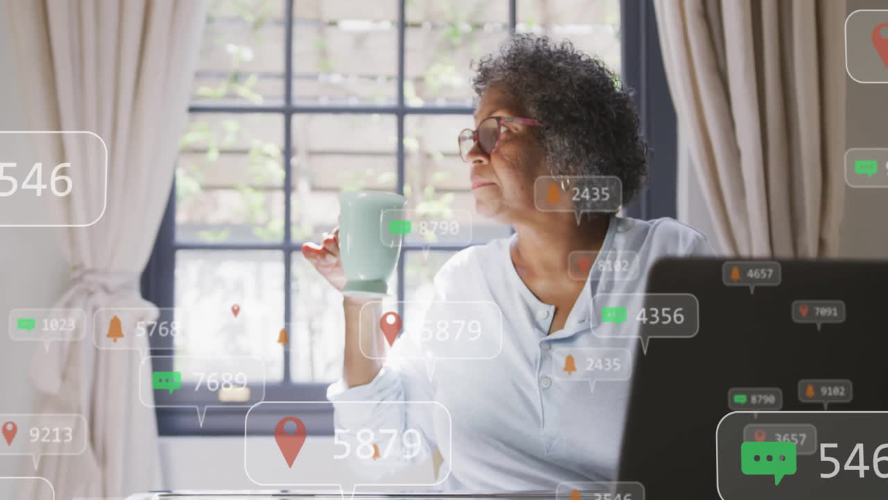 Social media notifications animation over elderly woman drinking coffee by window