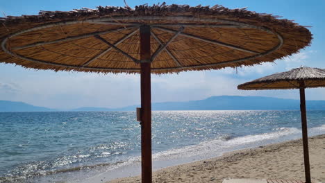 Reed-straw-beach-umbrella-the-sea-waves