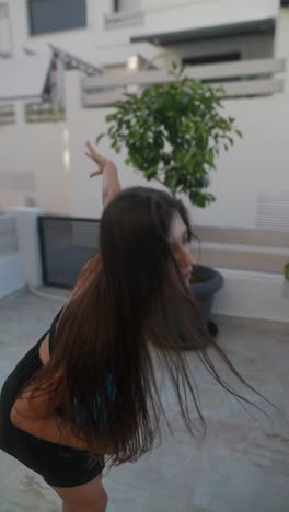 teenager playing with a blue balloon outdoors