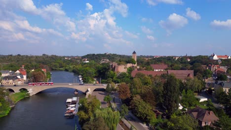drone view of giebichenstein fortress and the cityscape of halle - saale - in saxony anhalt, germany, on a sunny summer day. magic aerial view flight pull in drone