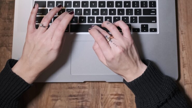 Woman Hands Typing on Laptop